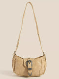 Tan multi-panel shoulder bag with buckle accent and adjustable strap.