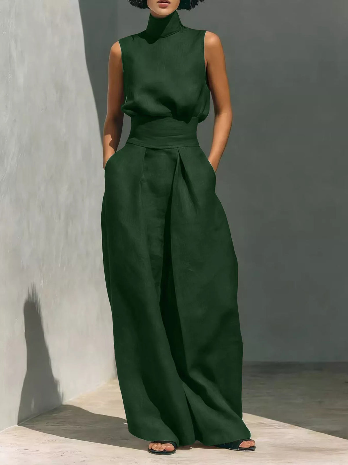 Sleeveless wide-leg jumpsuit in deep green with smocked waist and high neckline