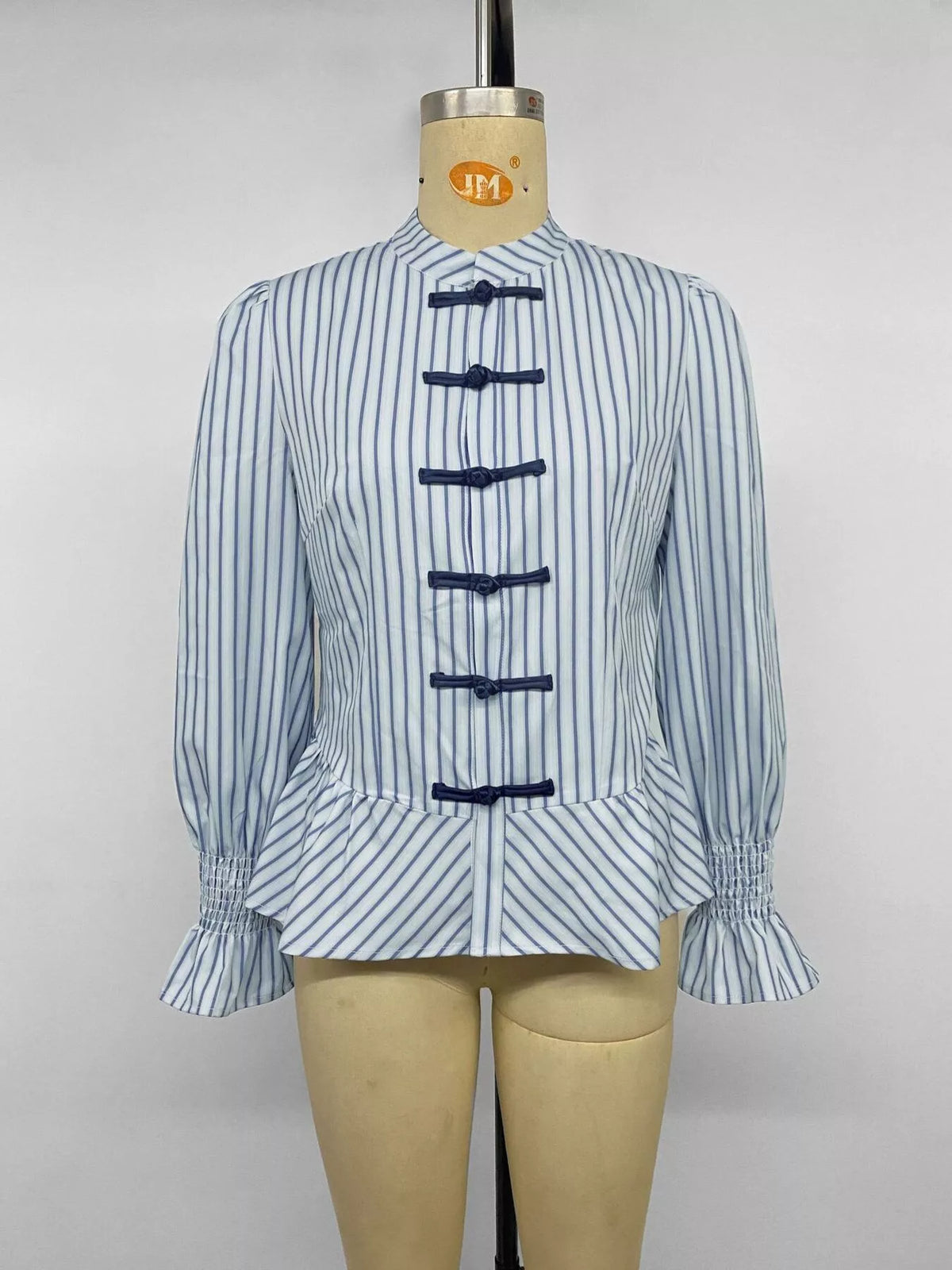Blue striped mandarin peplum shirt with buttoned stand collar and tied front