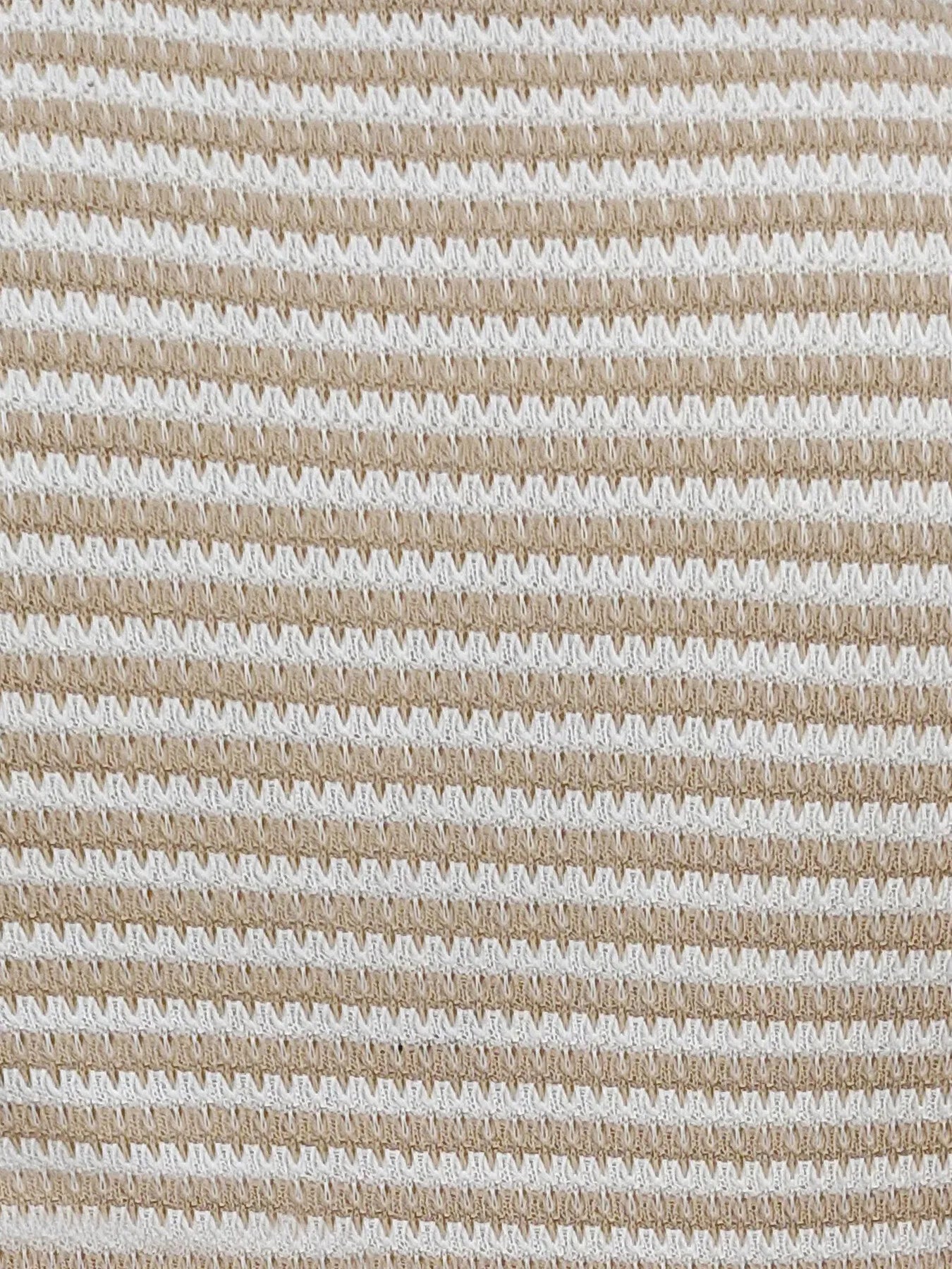 Close-up of cream-and-taupe striped knit tank top fabric texture