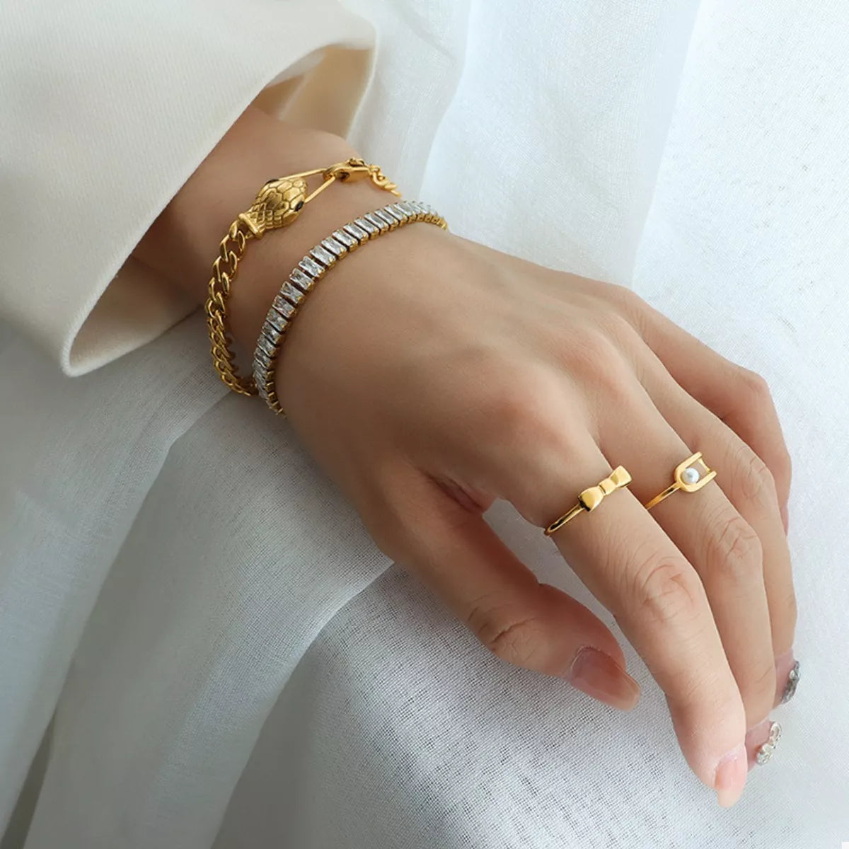 Gold chain bracelet with snake-head accent and secure clasp