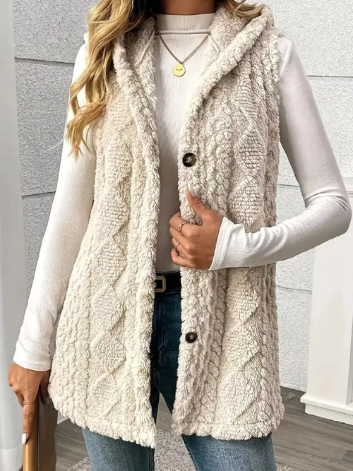 Beige sherpa hooded vest coat with button front and textured fleece, sleeveless layering piece.