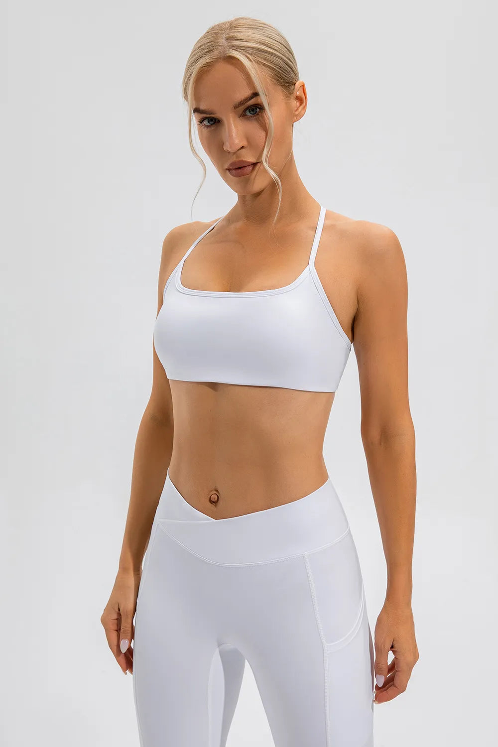 White active cami with thin spaghetti straps and scoop neckline, cropped fit