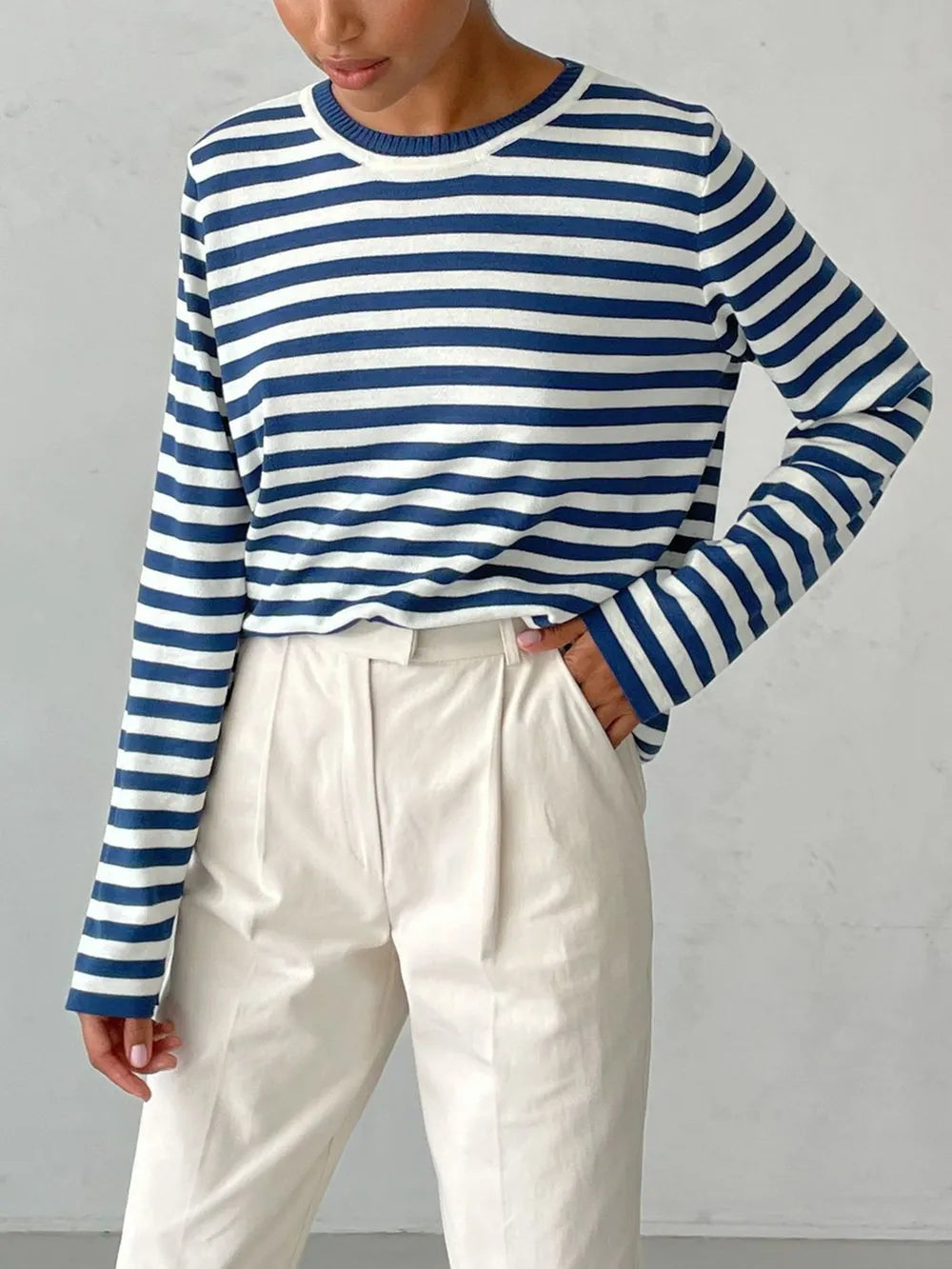 Striped long-sleeve sweater in navy and white with crew neck.