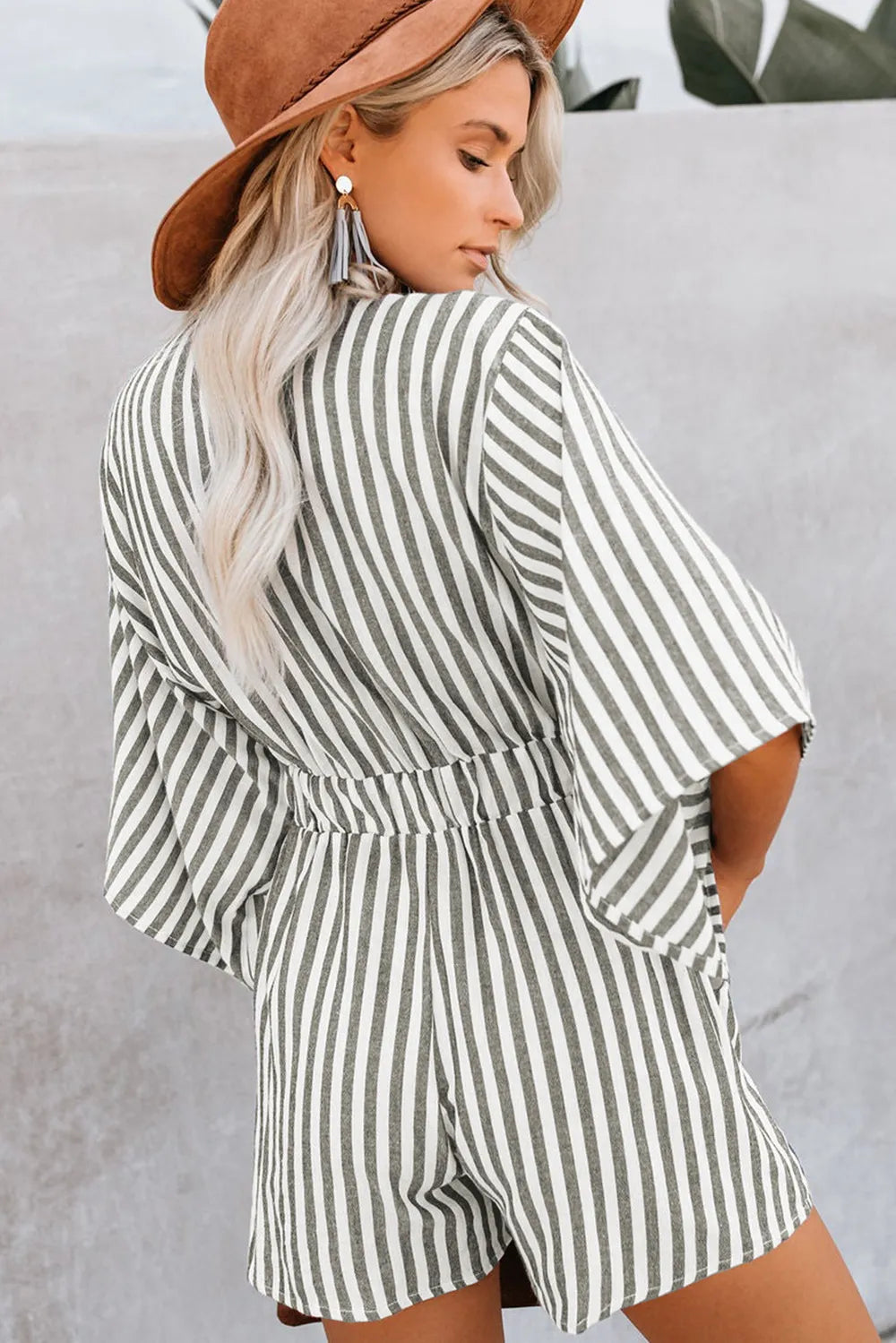 Striped kimono-sleeve romper with V neckline and gathered waist, vertical stripes