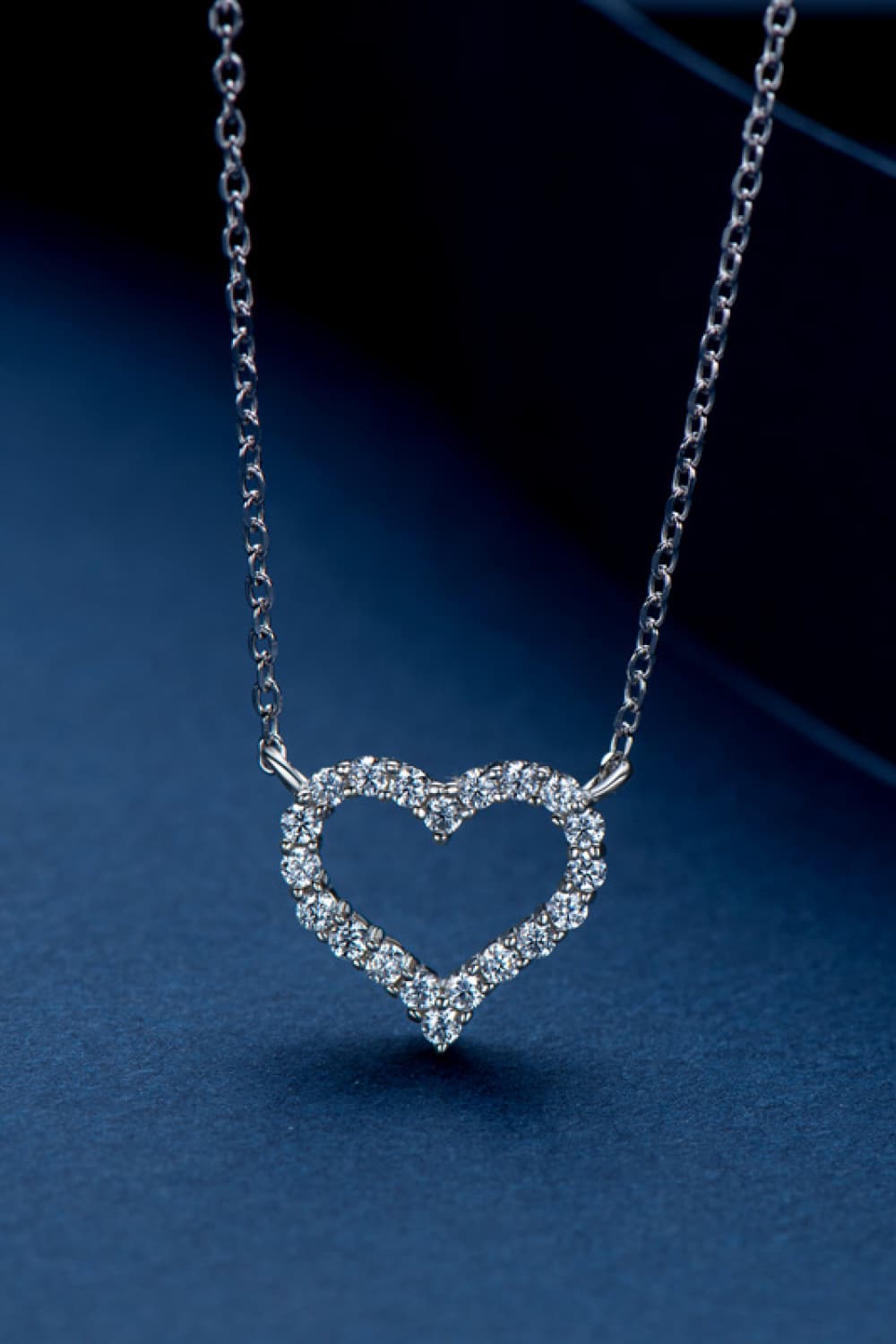 Heart-shaped pavé pendant necklace on a silver curb chain