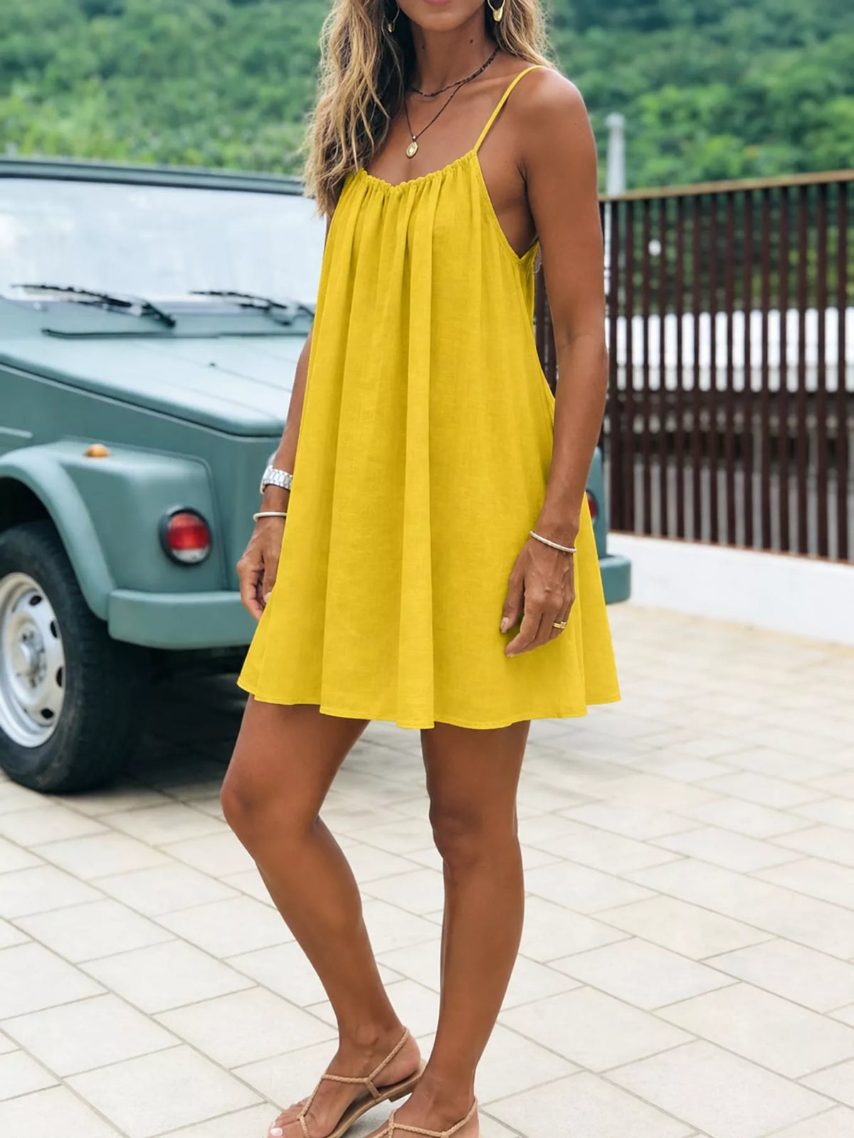 Yellow spaghetti strap ruched mini dress, gathered neckline and flared skirt