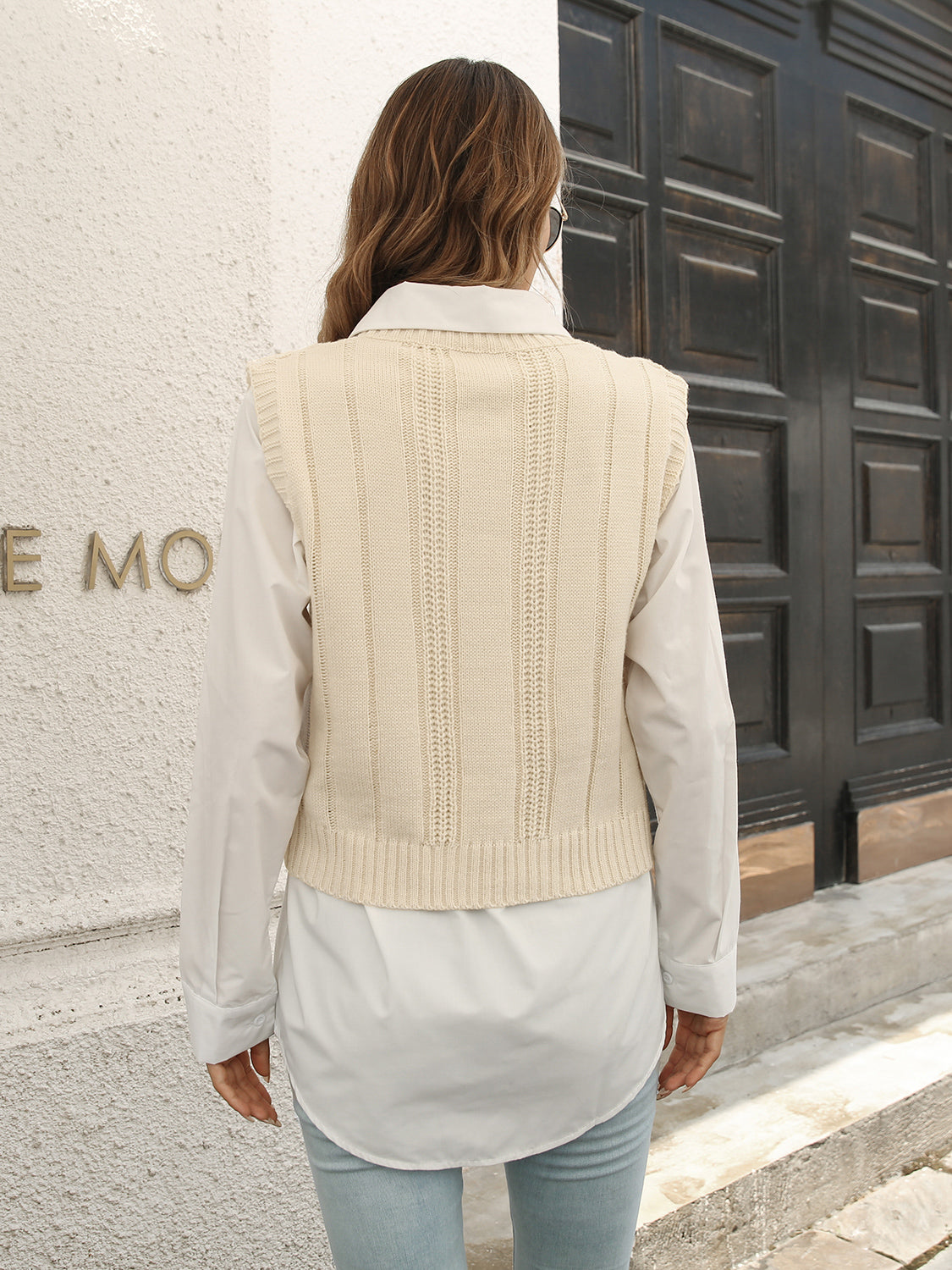 Ivory V-neck cable knit sweater vest, back view with vertical ribbing