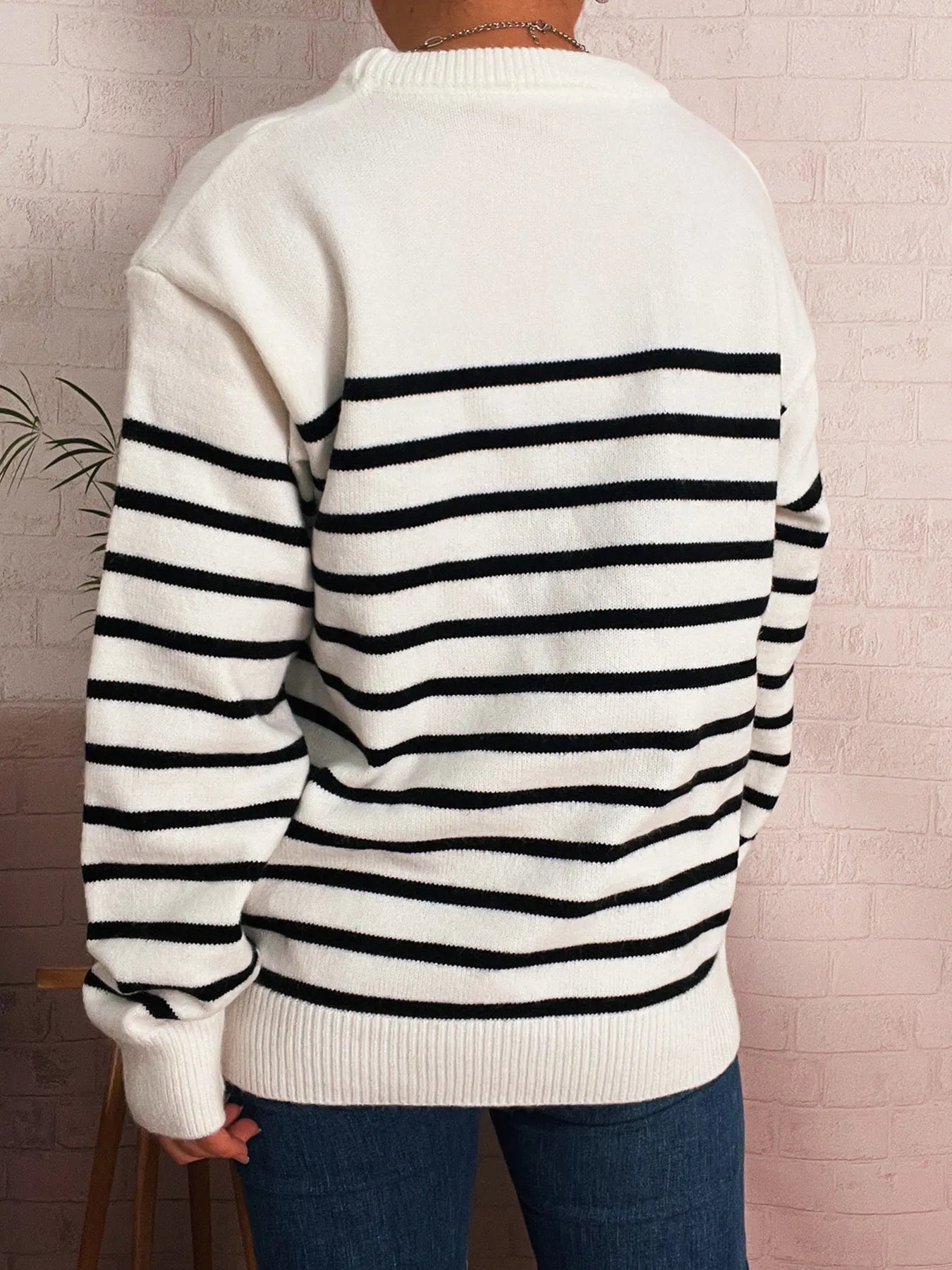 White striped drop-shoulder sweater, black horizontal stripes, ribbed cuffs and hem