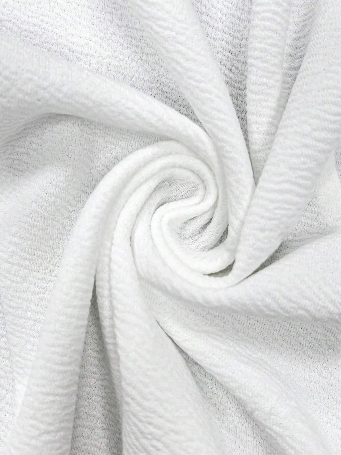 White blazer fabric close-up with textured woven texture