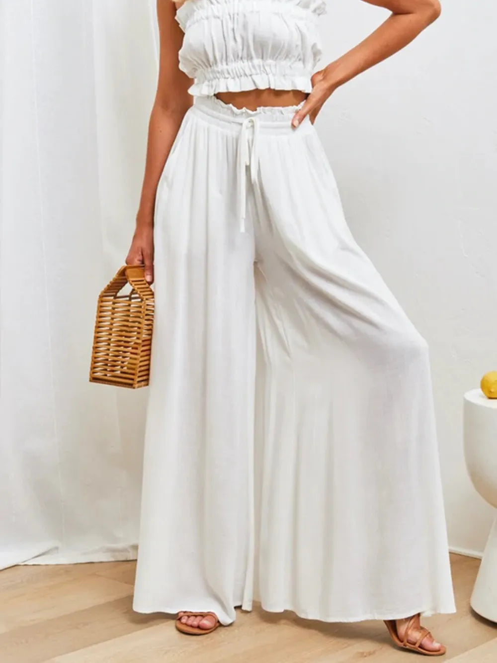 High-waist wide-leg pants in white with elastic drawstring waist and flowing wide legs