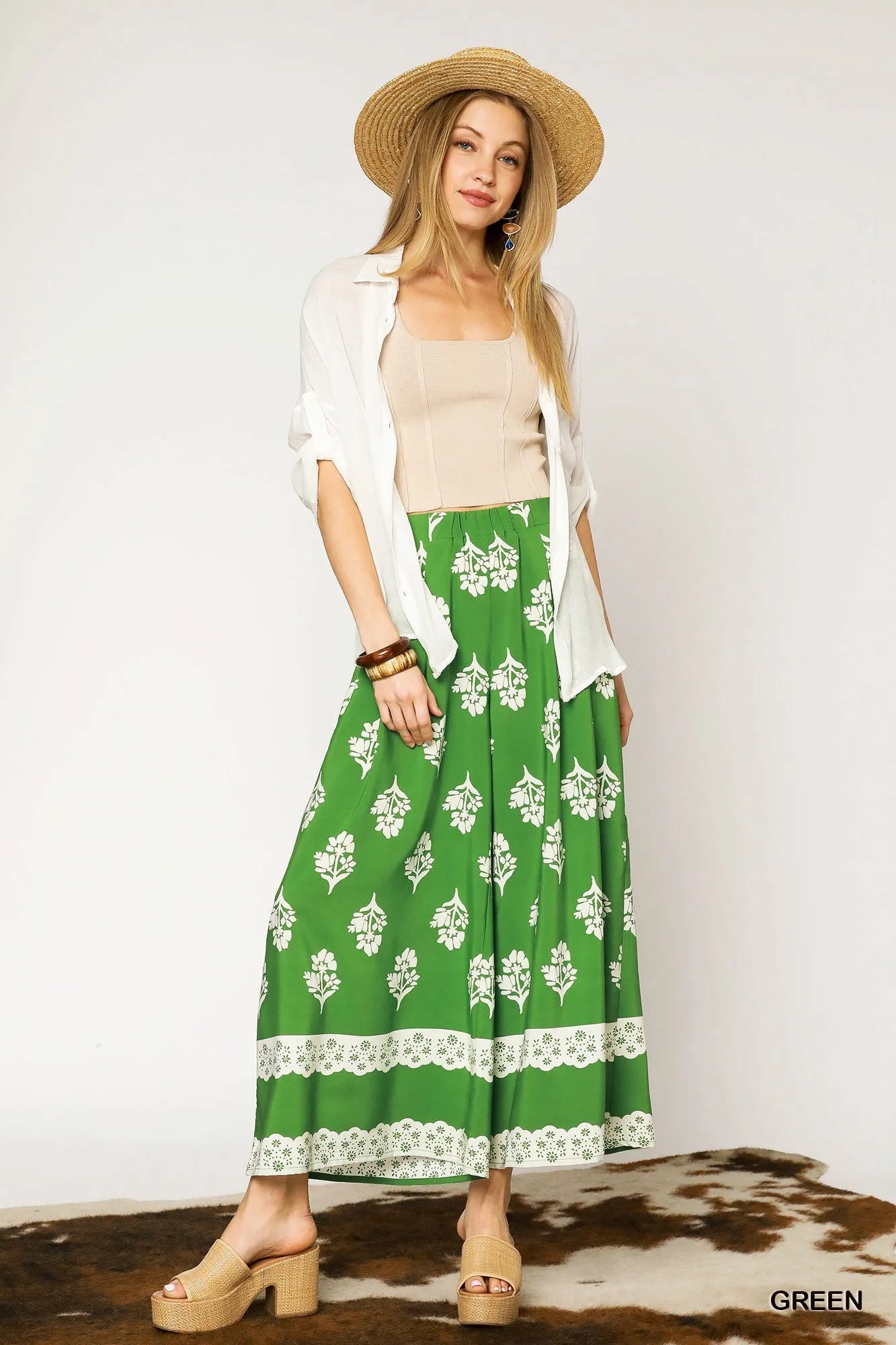 Green floral pleated wide-leg pants with white blossoms and lace-trimmed hem