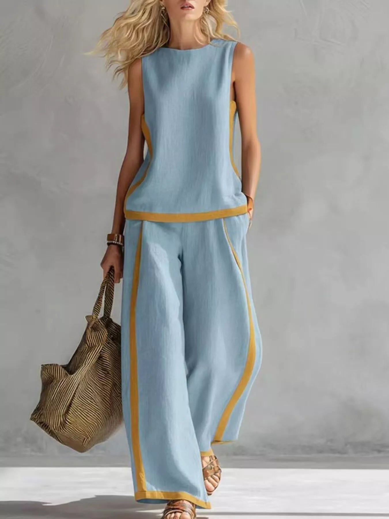 Light blue sleeveless top and wide-leg pants set with gold contrast trim