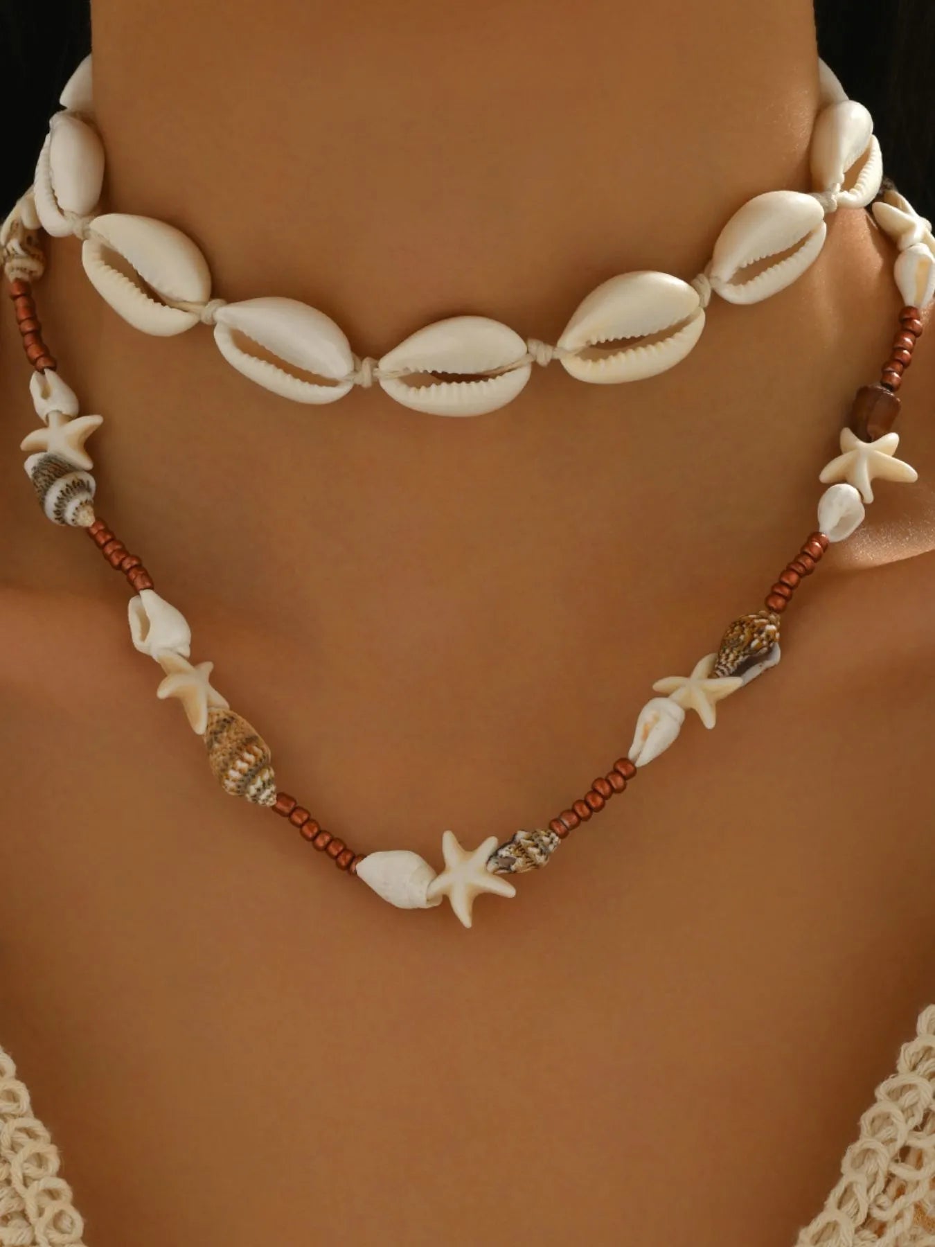 Double-layer shell necklace with cowrie shells, starfish charms, copper bead strand