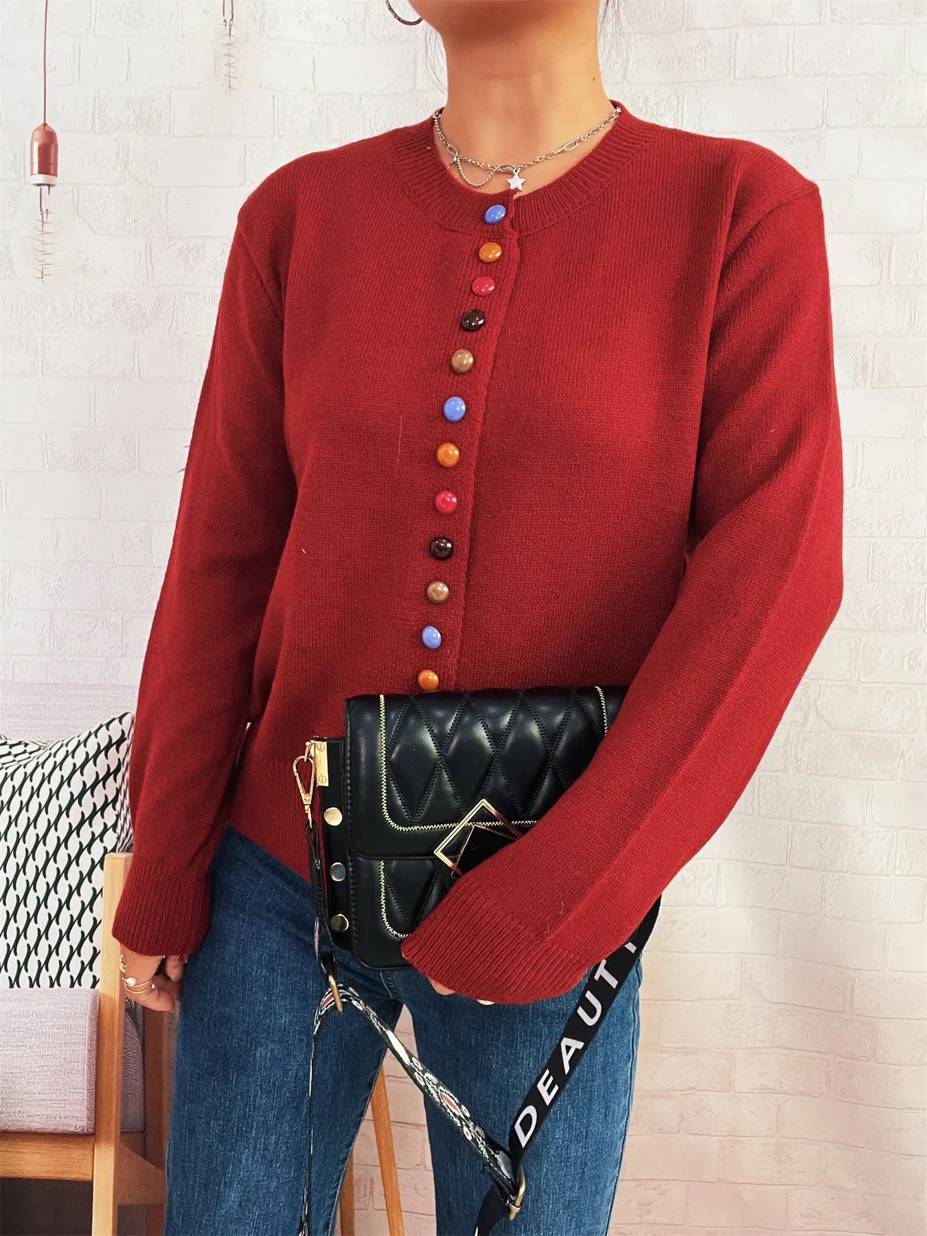 Red knit button-front cardigan with crew neck and vertical colorful button placket