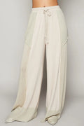 Cream wide-leg drawstring pants with elastic waist and side patch pockets