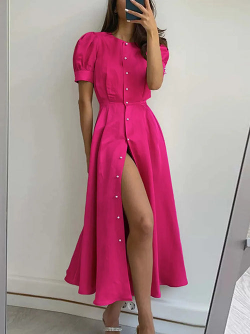 Hot pink button-down short-sleeve dress with puff sleeves, front buttons, and slit
