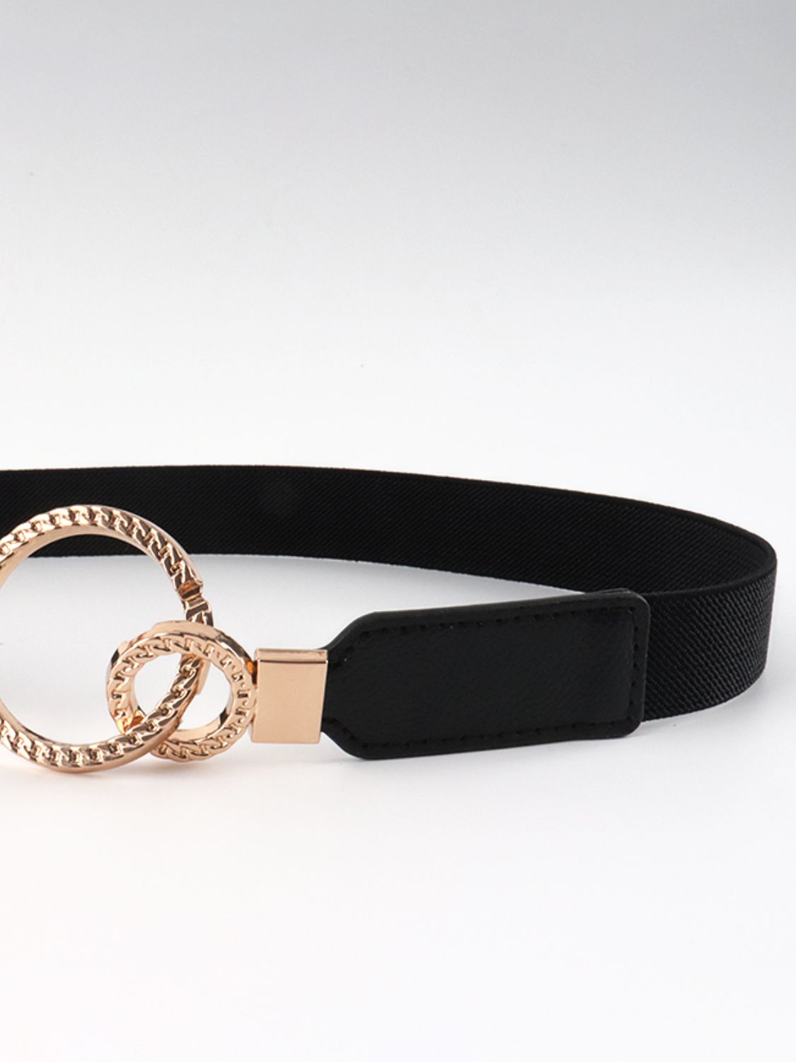 Black elastic vegan leather belt with gold-toned double rings and wide buckle panel