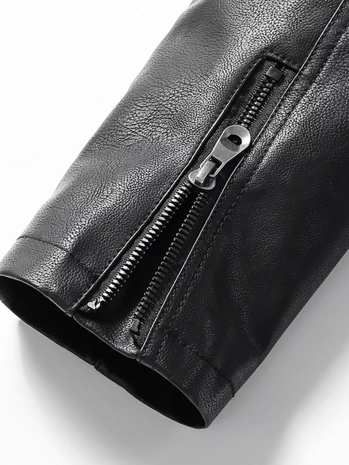 Men’s black vegan leather jacket sleeve cuff with visible zipper detail