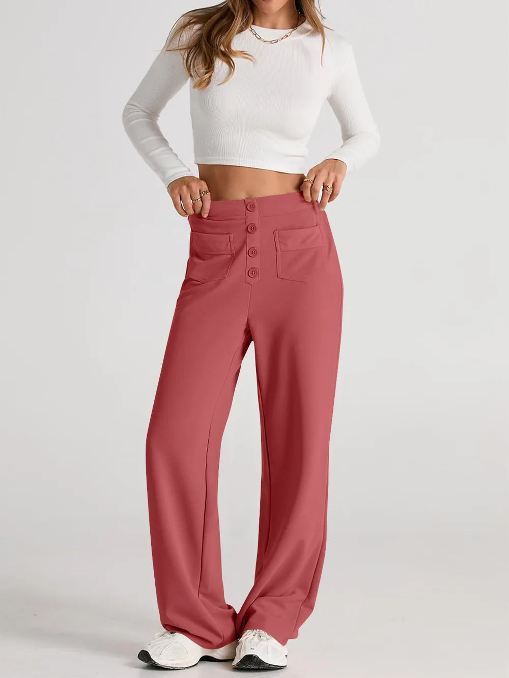 Orange-red high-waist wide-leg pants with front button closure and spacious pockets