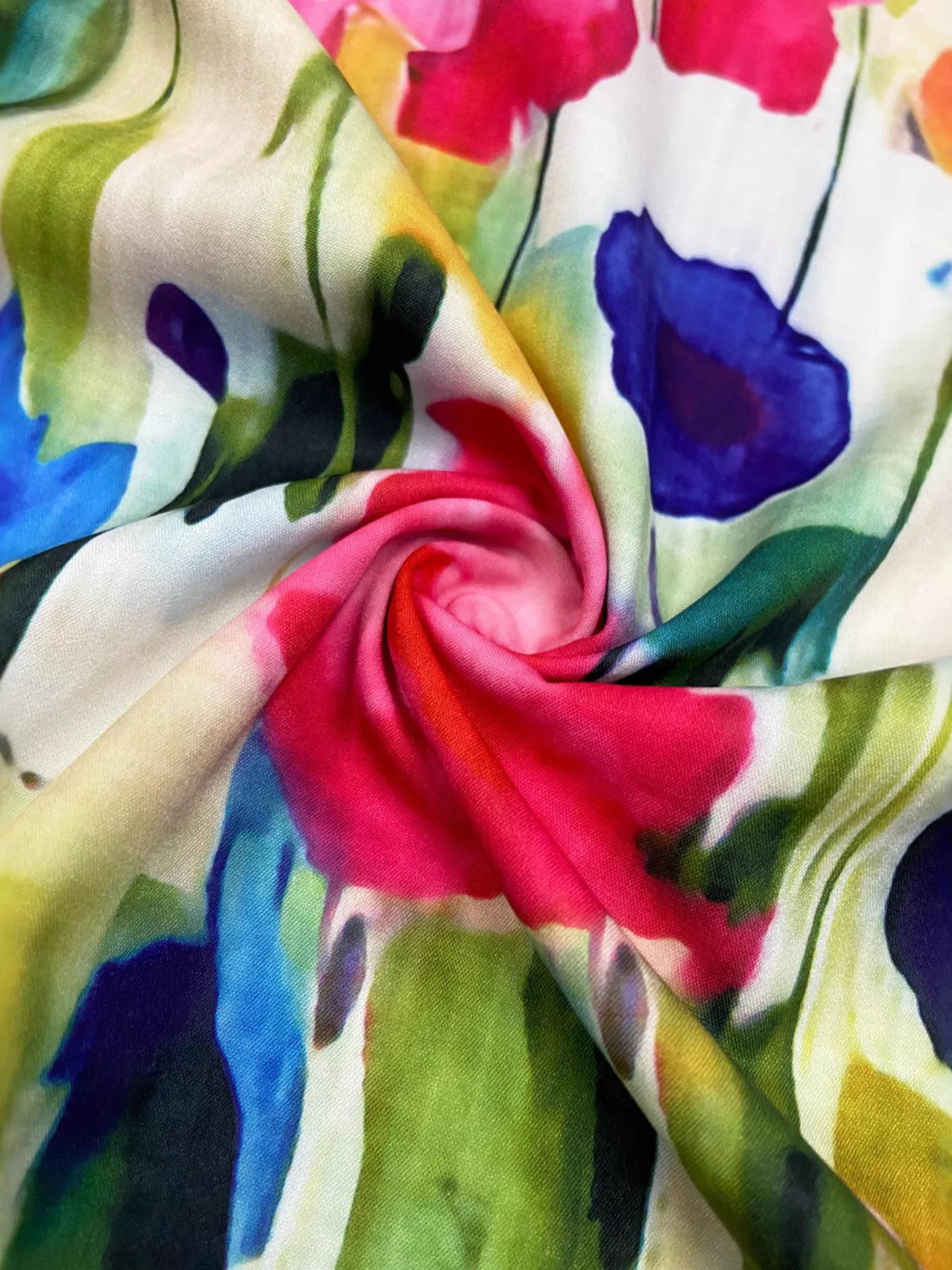 Multicolor floral fabric close-up with pink rosette and blue-green brushstrokes