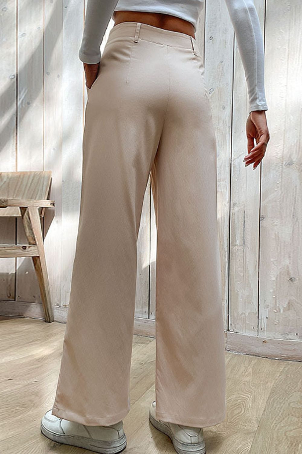 Beige wide-leg center-seam pants with high waist and belt loops