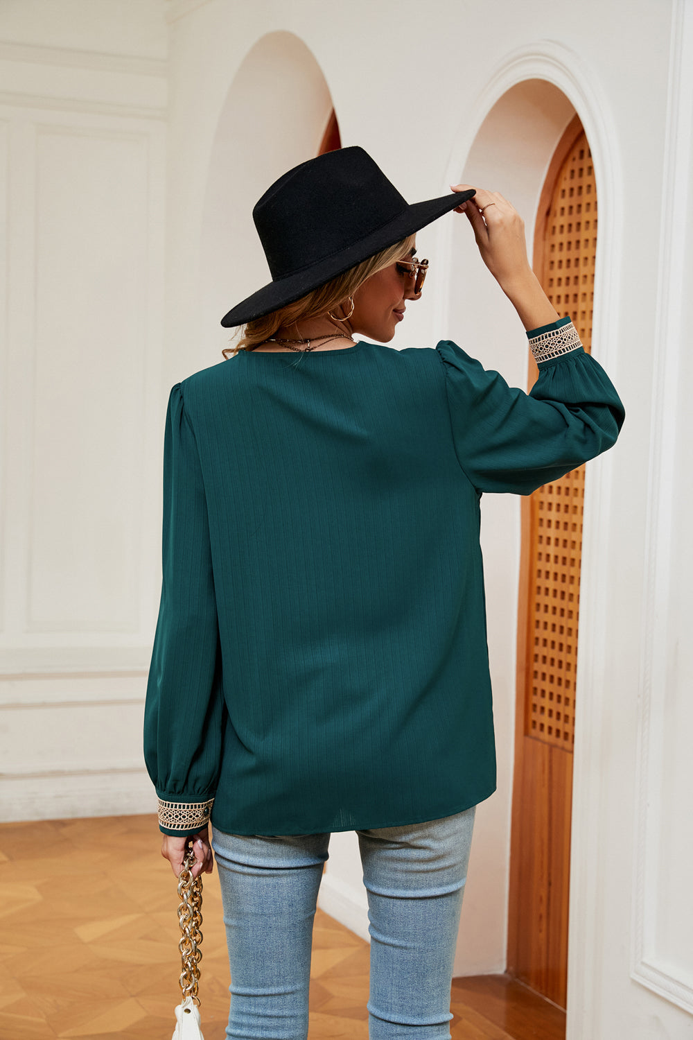 Green blouse with contrast cuff trim and long puff sleeves, back view