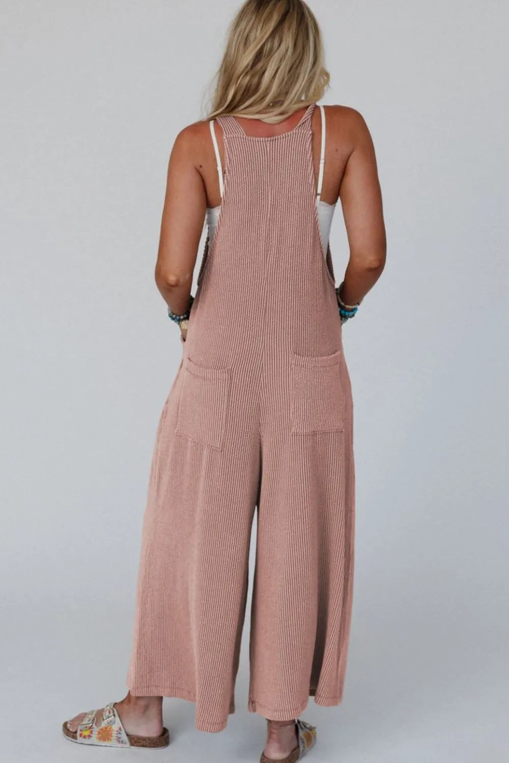 Dusty mauve wide-leg overalls with adjustable straps and panel-style front pockets