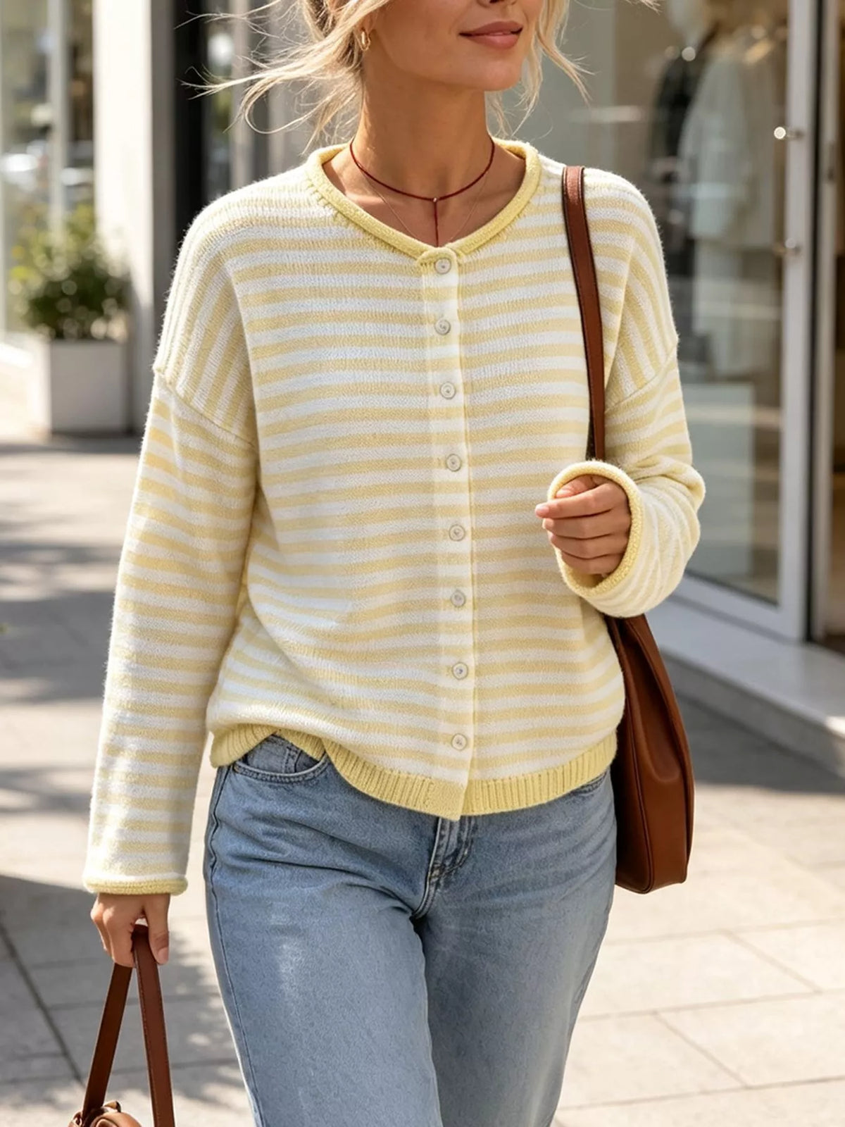 Yellow and white striped knit cardigan with round neckline and front buttons