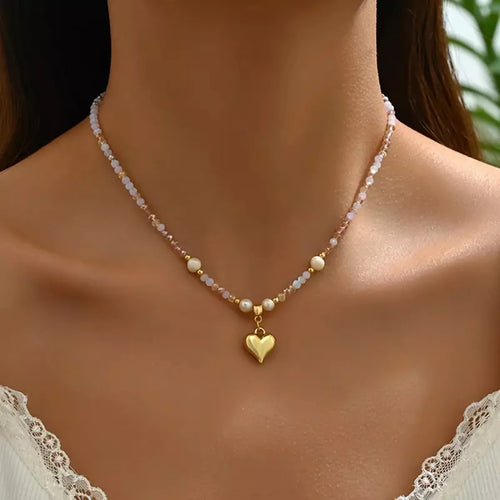Bead heart pendant necklace with gold heart charm on pink and white bead strand