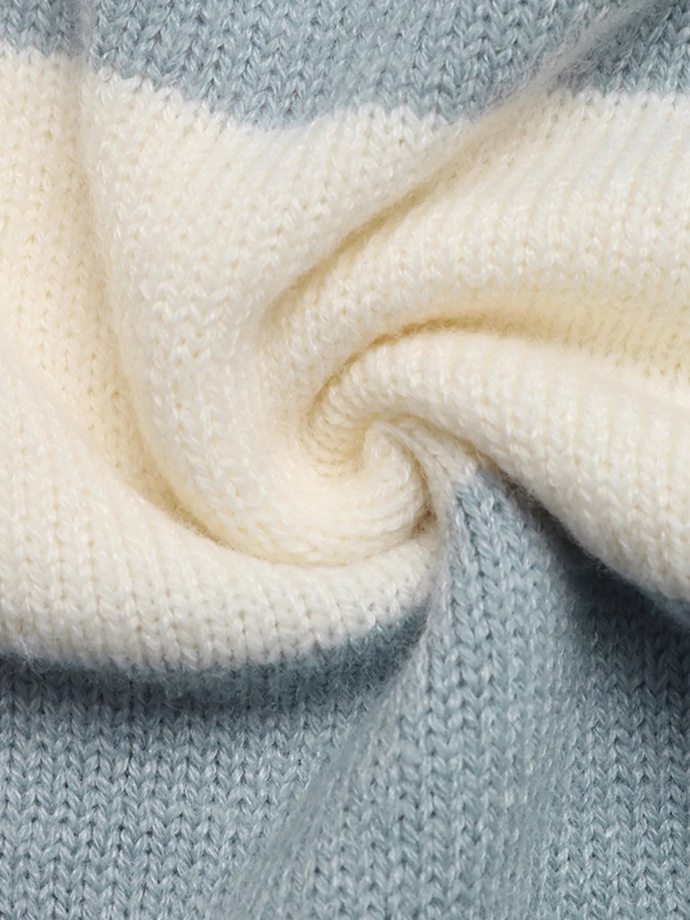Striped cardigan knit texture close-up, cream with light blue stripe section