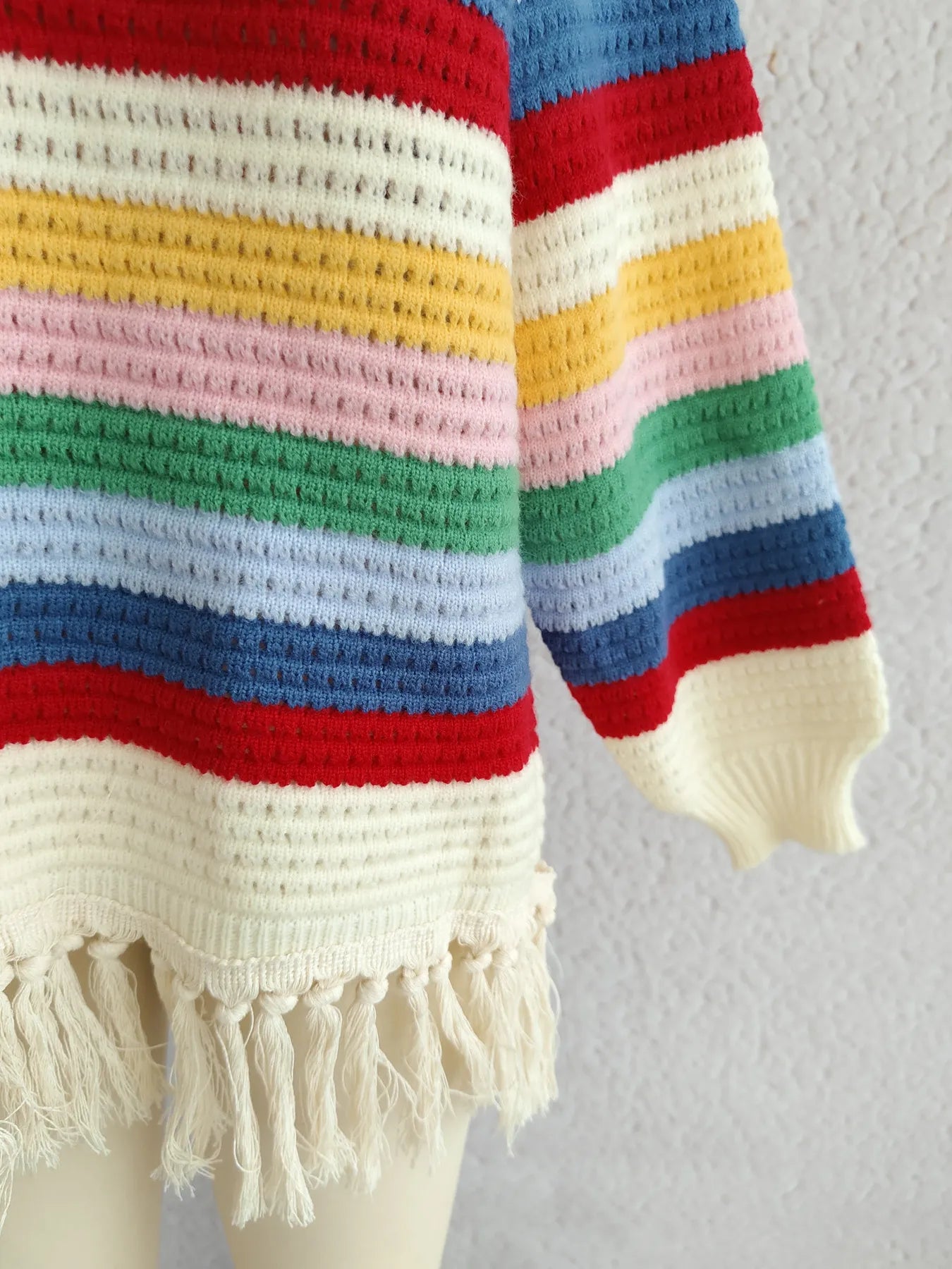 Rainbow striped long-sleeve sweater with ribbed cuffs and fringed tassel hem