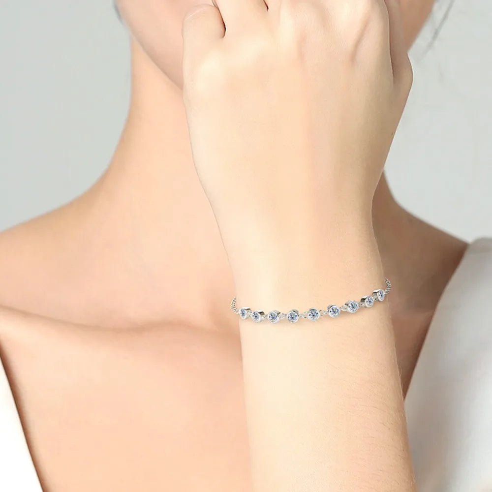 Gold-tone moissanite bracelet with small round blue stones
