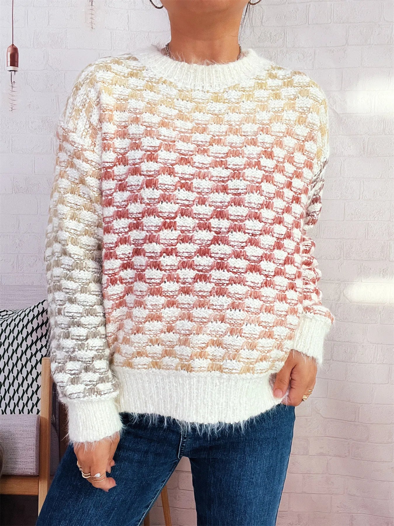 Cream round-neck sweater with long sleeves, red and gold textured knit pattern