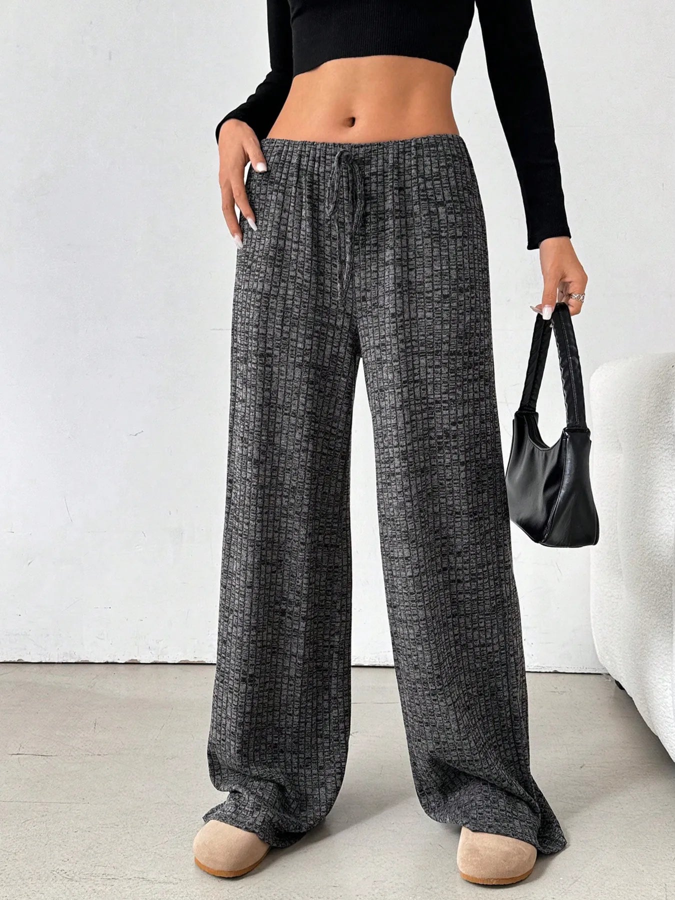 Dark charcoal patterned wide-leg drawstring pants with gathered waistband and tie