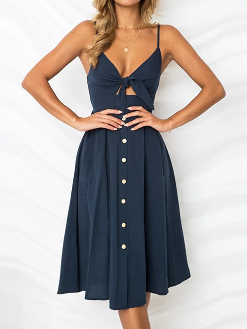 Dark blue cami dress with sweetheart cutout, bow tie front, button midi skirt
