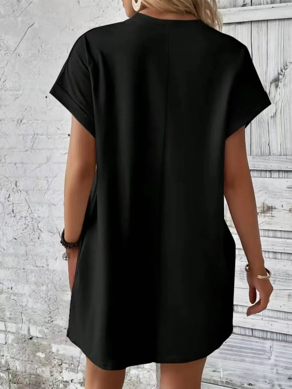 Black pocketed round-neck short-sleeve dress, back view, relaxed fit and side pockets