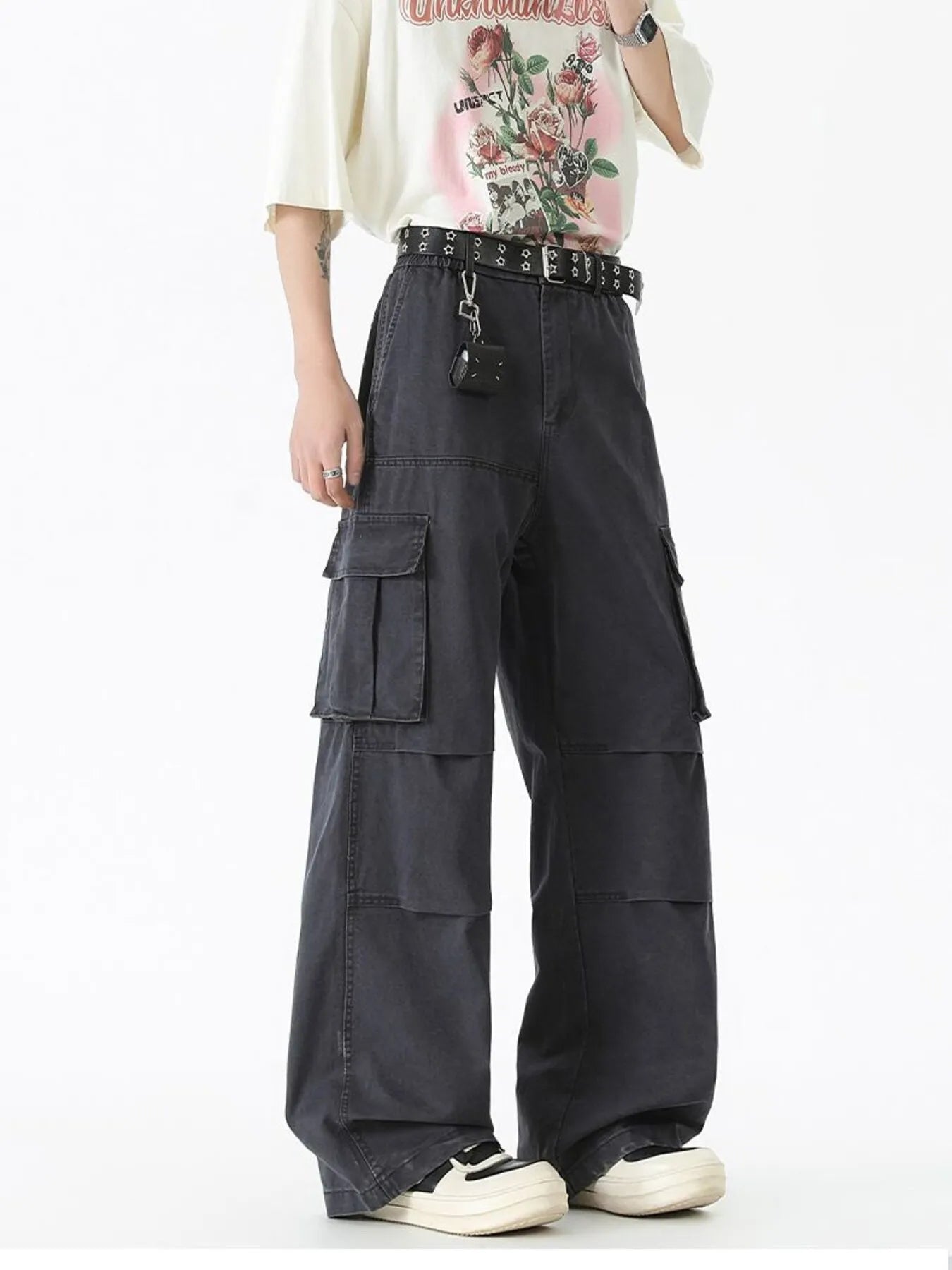 Black wide-leg cargo pants with flap pockets and studded belt at waist