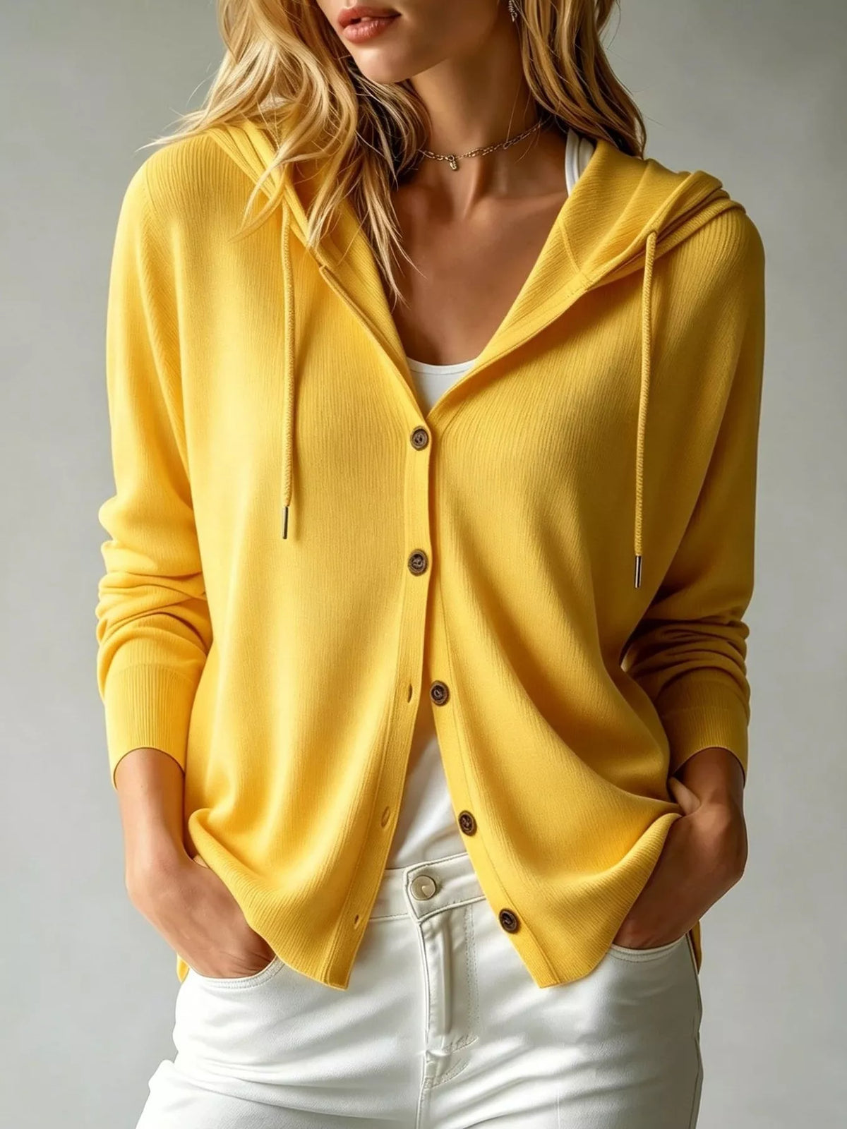 Mustard yellow hooded button cardigan with drawstring, front pockets, and long sleeves