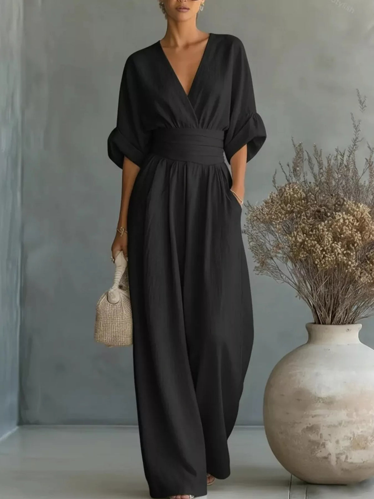 Black half-sleeve wide-leg jumpsuit with V-neck and gathered waist