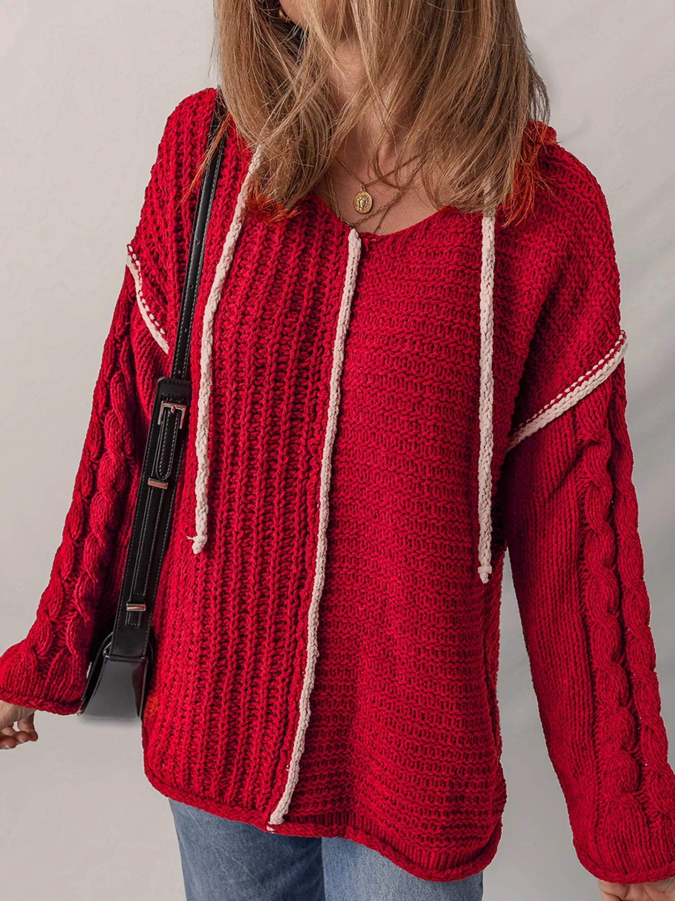Deep red hooded knit sweater with white contrast trim and visible drawstring ties