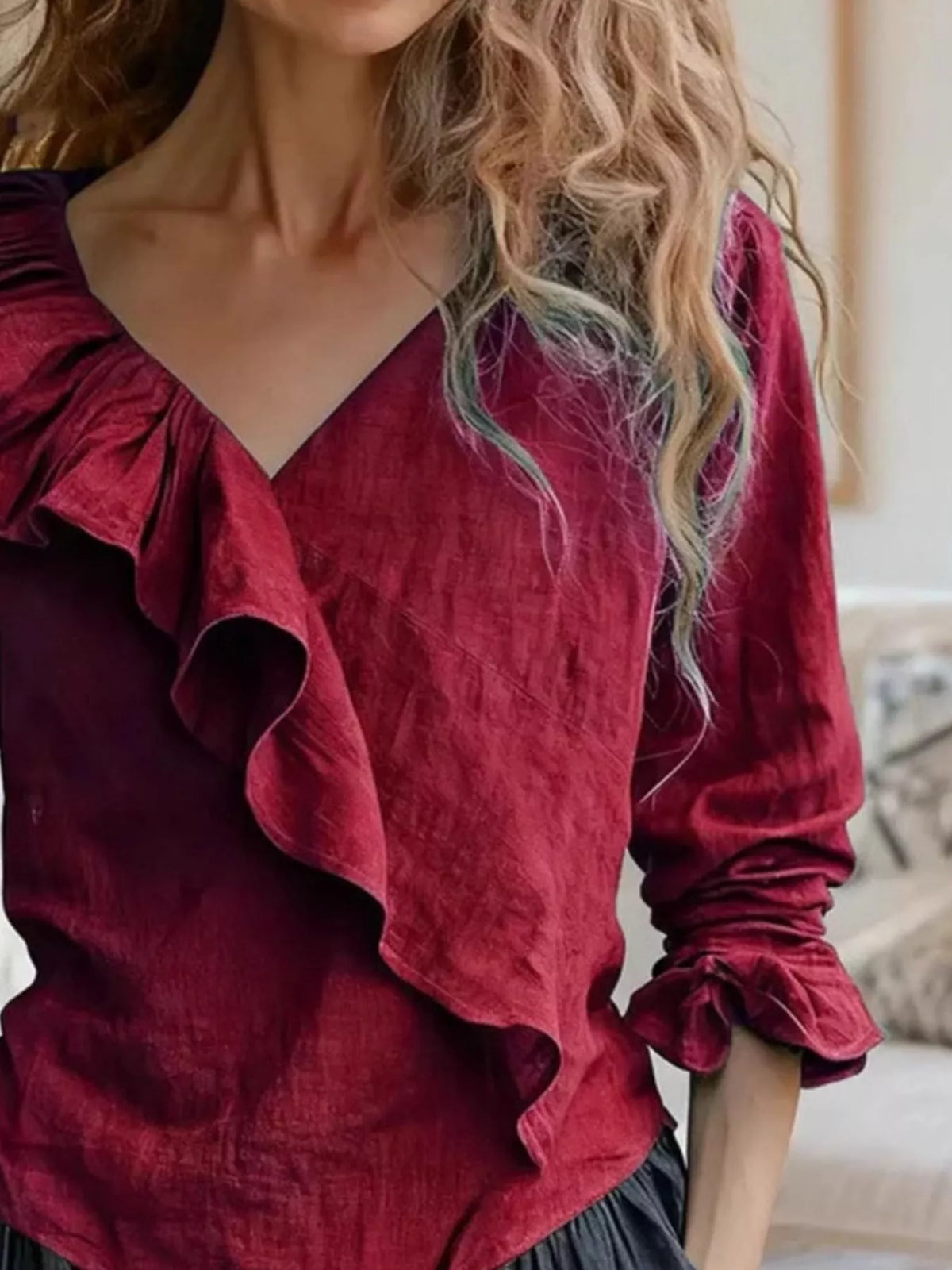Burgundy ruffled V-neck long-sleeve blouse, close-up of layered ruffle detail at chest