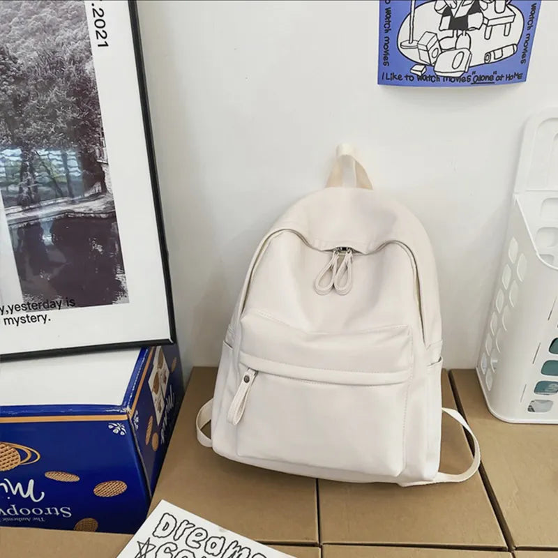 Ivory vegan leather zip backpack with front zip panel and adjustable shoulder straps