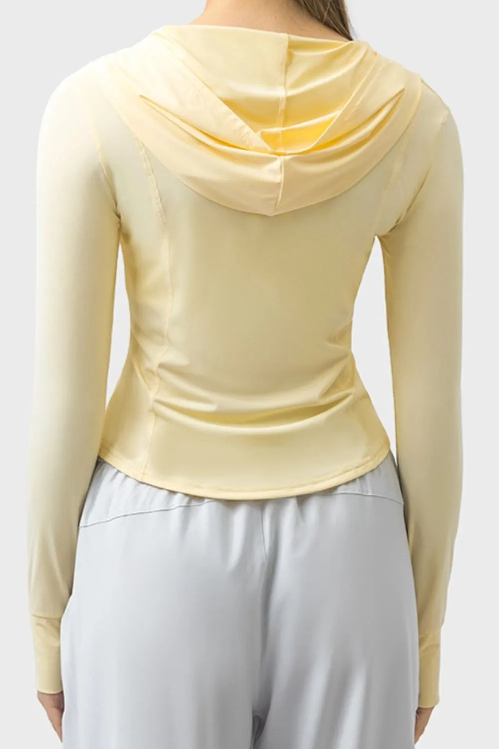 Light yellow zip-up hooded active jacket with hood detail and long sleeves