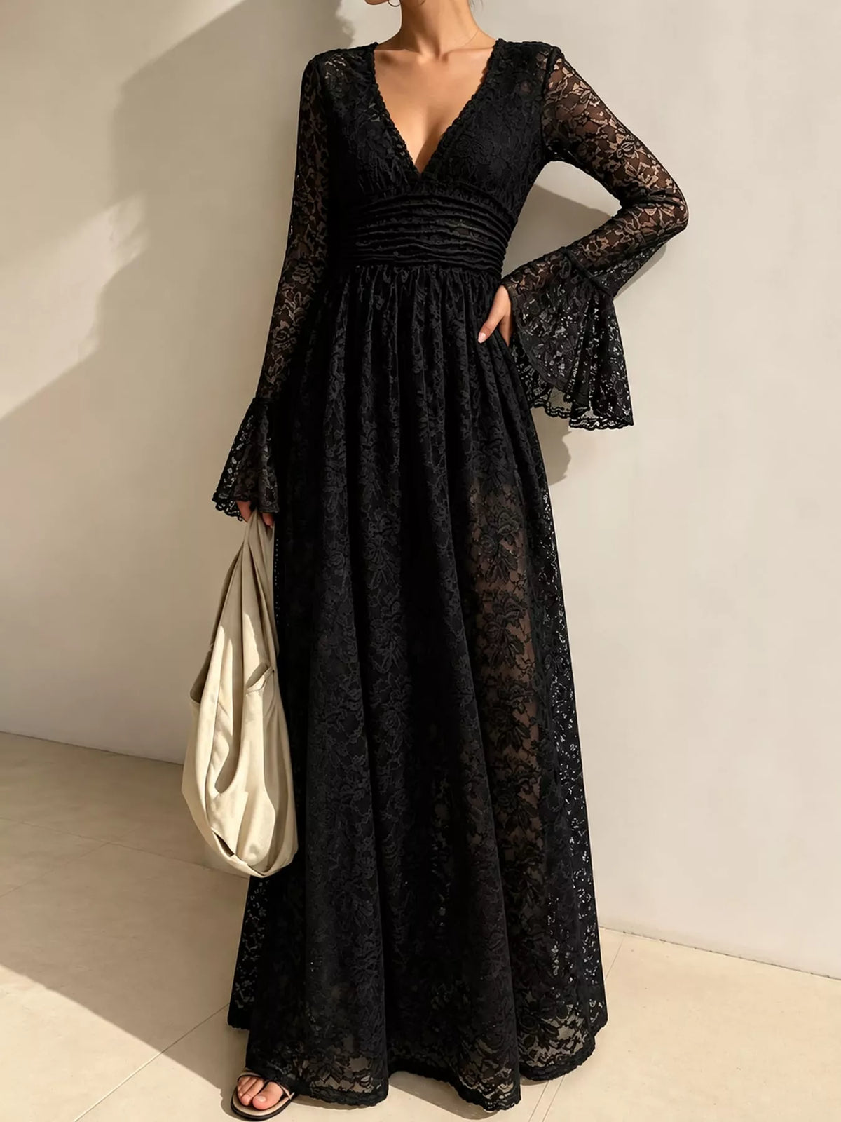 Black lace maxi dress with ruched V-neck and long flared sleeves, A-line skirt.