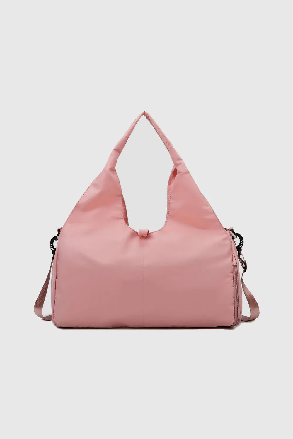 Waterproof travel tote bag in dusty pink, top handle and adjustable shoulder strap.