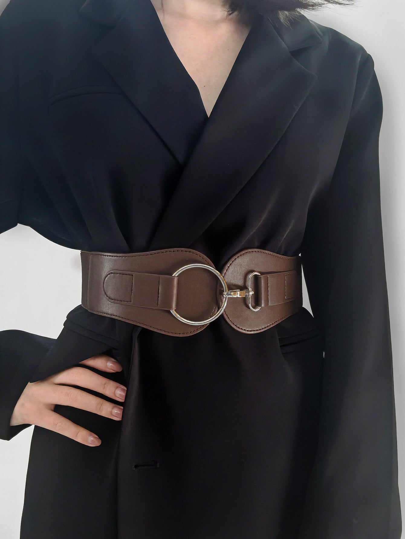 Caramel brown wide elastic belt with silver O-ring and clasp buckle on waist