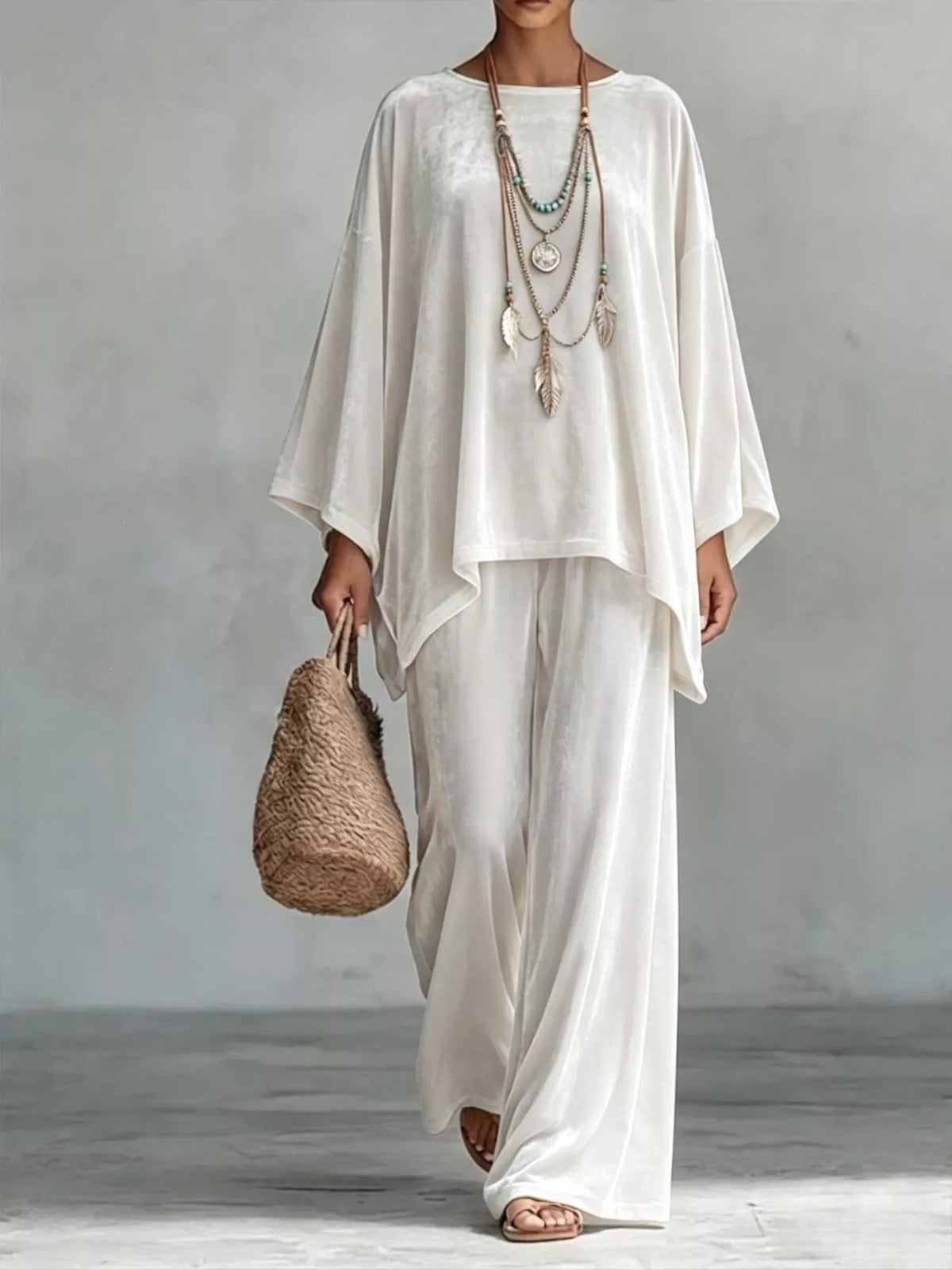 White velvet wide-leg pants set with loose asymmetrical poncho-style top