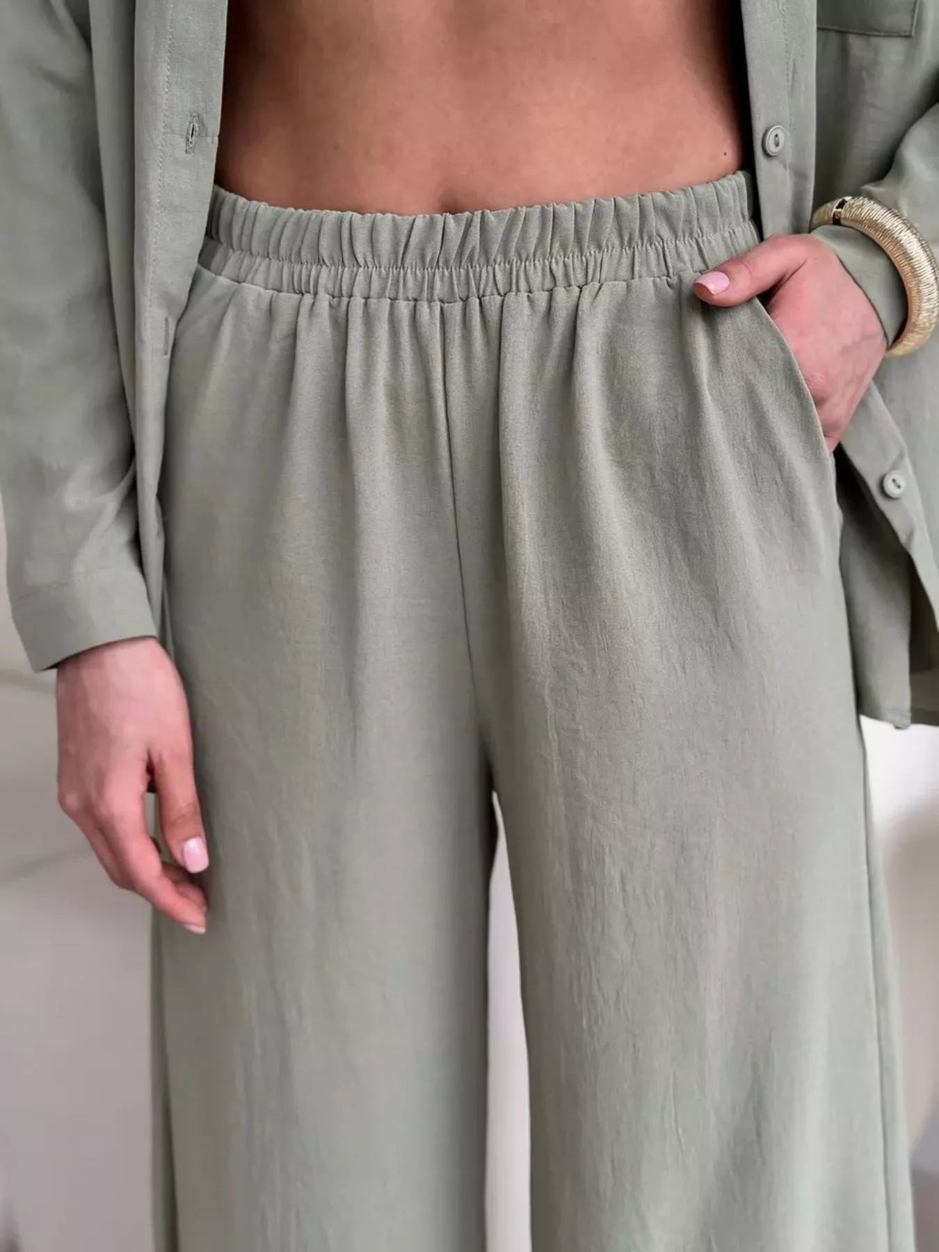 Sage green wide-leg pants with gathered elastic waistband in matching fabric