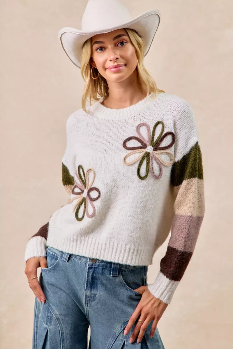 Ivory flower color block sweater with embroidered flowers on front and striped color-block sleeves